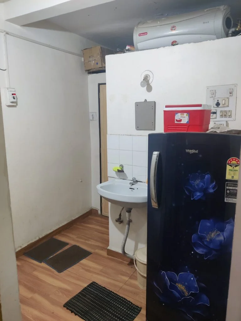 Utility area at LK Vet Care featuring a sink, refrigerator, and water heater